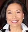 Asian woman headshot photo smiling with dark hair and white blouse